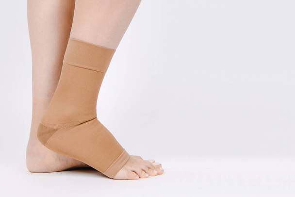 Orthopedic Ankle Brace. Medical Ankle Bandage. Medical Ankle Support Strap Adjustable Wrap Bandage Brace foot Pain Relief Sport. Leg Brace isolated on white background. Trauma Ankle orthosis. Injury - Fotó, kép