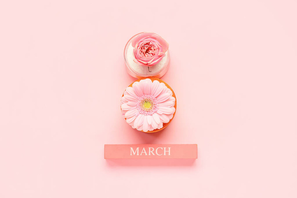Composition with beautiful flowers, ribbons and word MARCH on pink background. International Women's Day celebration - Foto, Imagem