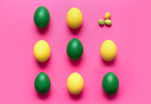 Different painted Easter eggs on color background - Foto, afbeelding