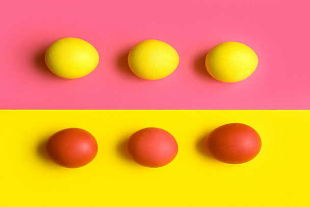 Red and yellow Easter eggs on color background - Zdjęcie, obraz
