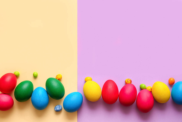 Different painted Easter eggs on color background - 写真・画像