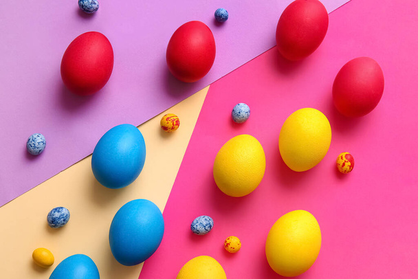 Different painted Easter eggs on color background - Photo, Image