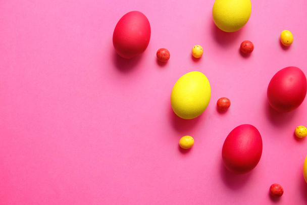 Red and yellow Easter eggs on color background - Photo, Image