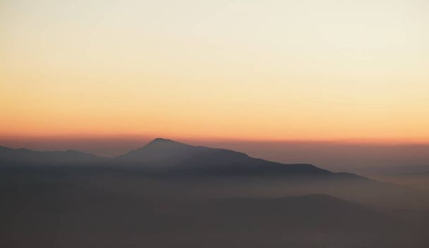Mountain peak with fog on dusk - 写真・画像