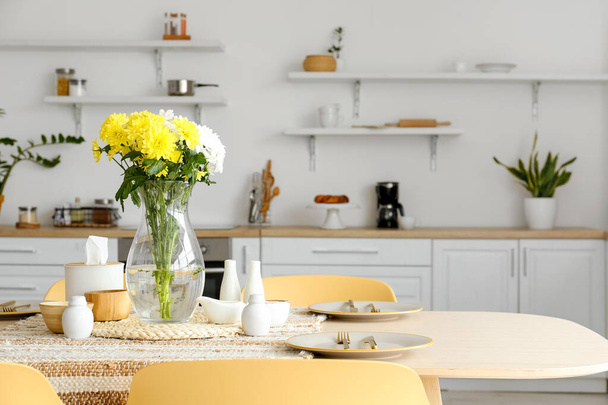 Dining table with setting and vase served for International Women's Day celebration in modern kitchen - Foto, Imagen