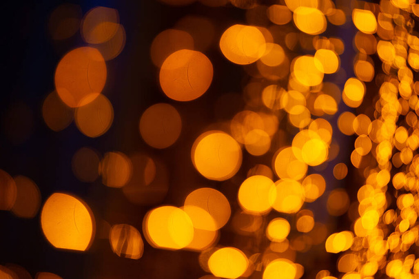 Abstrakter Hintergrund mit Bokeh defokussierten orangen Lichtern. - Foto, Bild