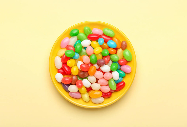 Plate with different jelly beans on beige background - Valokuva, kuva