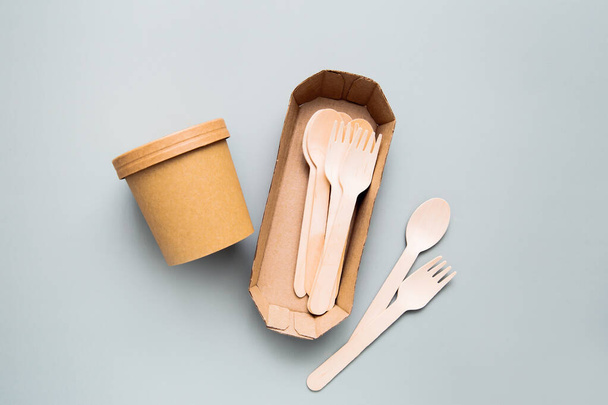 Zero waste, environmentally friendly, disposable, cardboard, paper utensils on a blue background. View from the top. Eco craft paper tableware. - Photo, Image