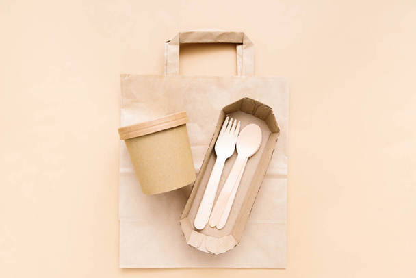 Zero waste, environmentally friendly, disposable, cardboard, paper utensils on a beige background. View from the top. Eco craft paper tableware. - Fotografie, Obrázek
