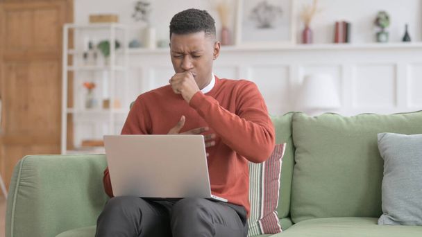 African Man with Laptop Coughing on Sofa - Foto, Imagem