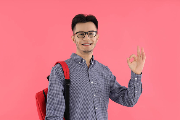 Male student with backpack on pink background - Photo, Image