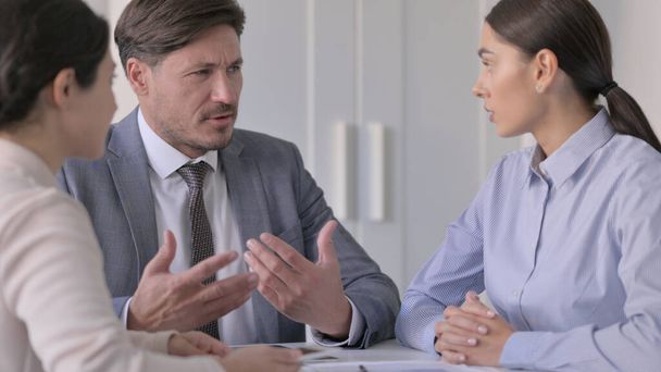 Middle Aged Businessman Talking to Female Colleagues in Office - Foto, Imagem