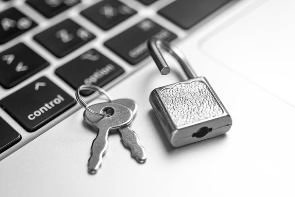 Computer security concept. Padlock on computer keyboard, laptop in office. Cyber security and privacy background - Photo, Image