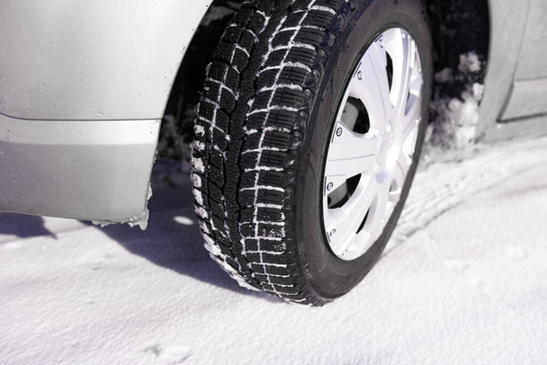 Car tires on winter snow road close up - Foto, Imagem