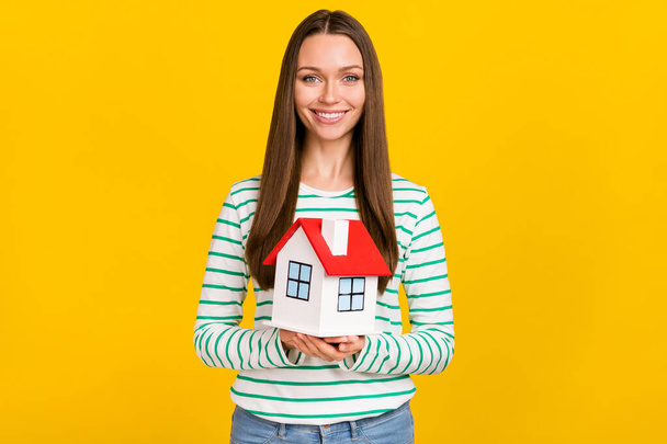 Photo of young pretty woman buy house relocation real estate settlement isolated over yellow color background - Фото, зображення