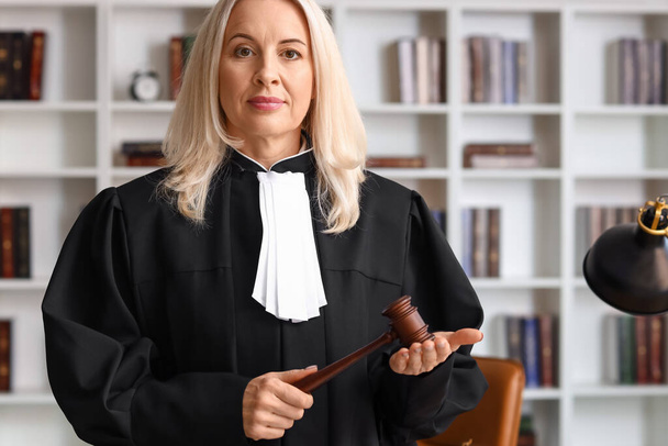 Mature female judge with gavel in courtroom - Photo, Image