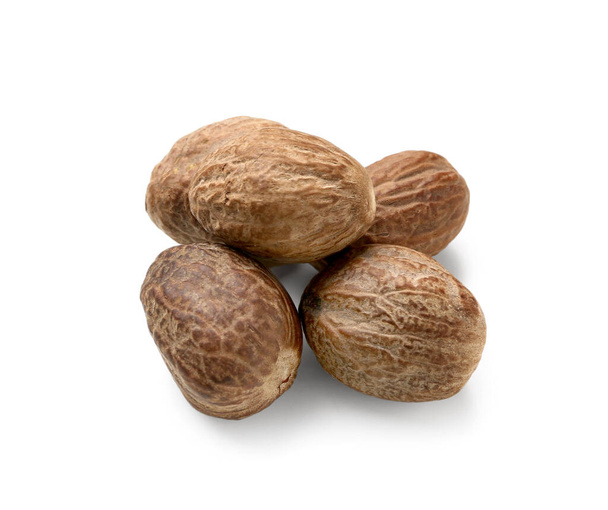 Вкусные мускатные орехи изолированы на белом - Фото, изображение