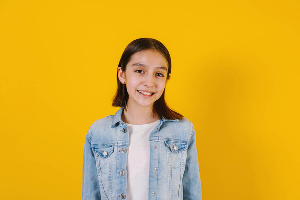 Portrait of latin child girl on yellow background in Mexico Latin America - Photo, Image