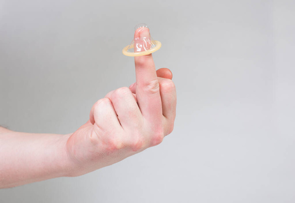 Safe sex condom in man's hand, contraceptive - Foto, imagen