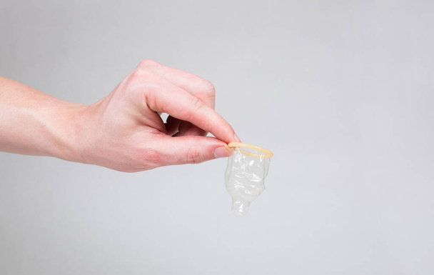 Safe sex condom in man's hand, contraceptive - Photo, Image