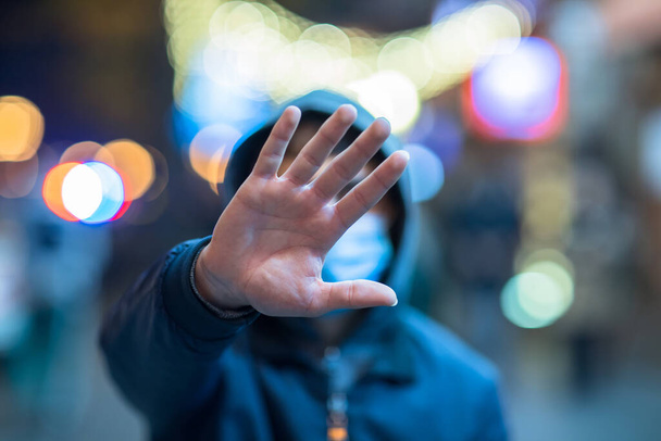 homem em máscara mão parar sinal em stree - Foto, Imagem