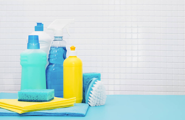 Set de limpiadores y detergentes, accesorios de limpieza, fondo azul con azulejos. Concepto primavera limpieza regular - Foto, imagen