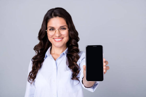 Photo of positive lady hold phone show covid green certificate wear specs blue shirt isolated grey color background - Photo, Image