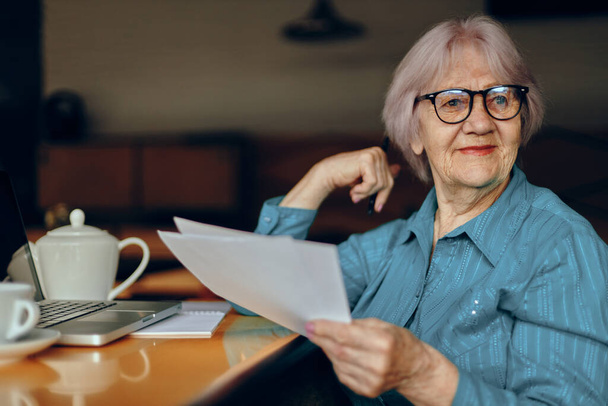 elderly woman working in front of laptop monitor sitting Lifestyle unaltered - Fotoğraf, Görsel