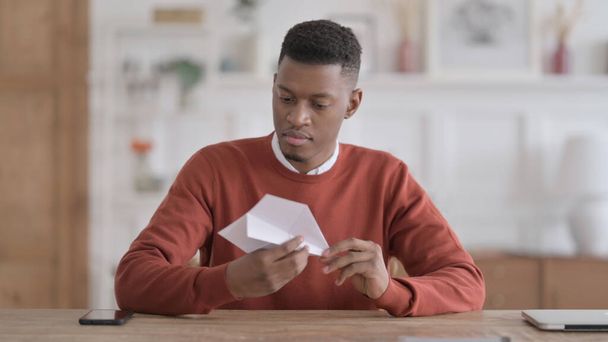 African Man Making Paper Plane while Sitting in Office - Photo, Image