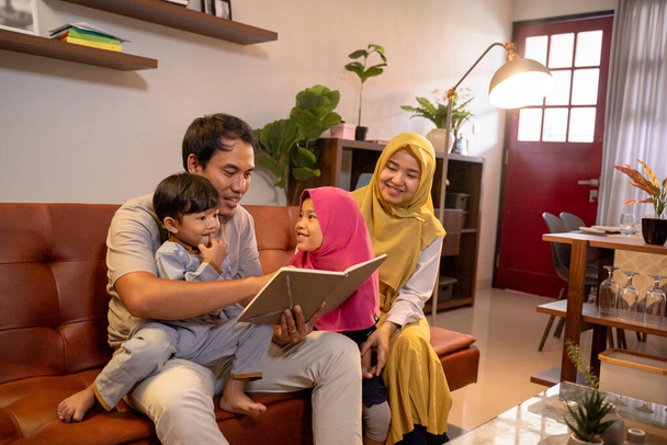 Asian muslim family having fun in livingroom - Фото, изображение