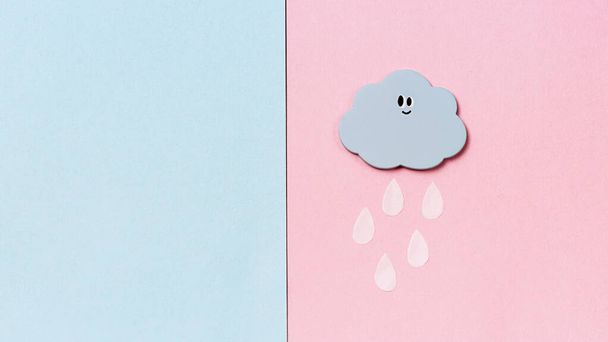 Small Handmade Toy in Shape of Clouds with Rain on Blue and Pink Background with Copy Space HandMade Toys Abstract Sky - 写真・画像