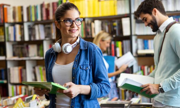 Group of happy college students studying in the school library. Education people exam university concept - Fotoğraf, Görsel