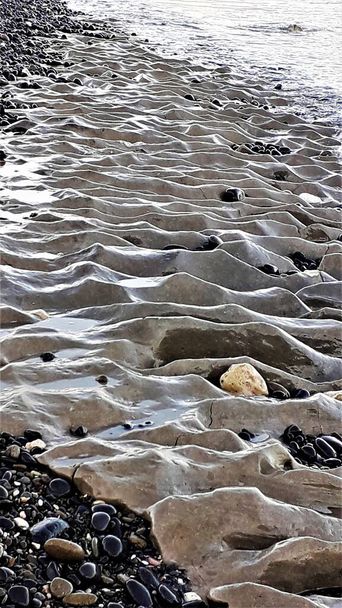 Fotografia skamieniałego piasku plażowego w Parku Narodowym Cabo de Gata, Andaluzja, Hiszpania, - Zdjęcie, obraz