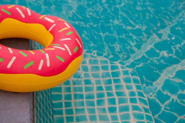 Rubber ring in blue swimming pool background - Photo, Image