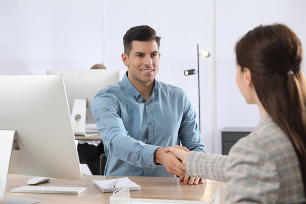 Employee shaking hands with intern in office - Foto, immagini