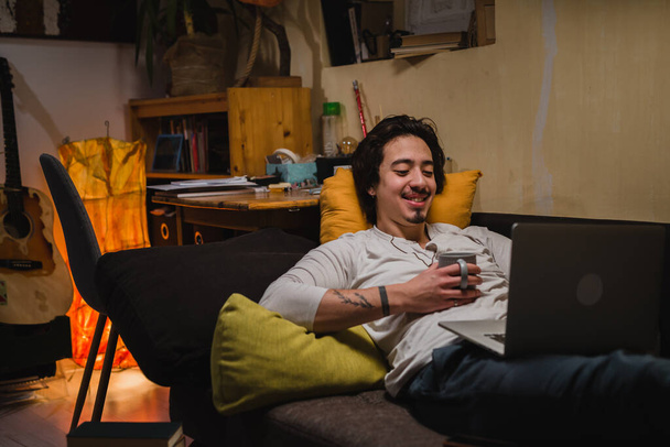 man using laptop computer in his room - Фото, зображення