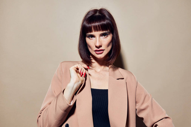 photo pretty woman short haired suit gesturing with hands isolated background - Фото, зображення