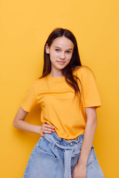 young beautiful woman in a yellow t-shirt emotions summer style isolated background - Fotografie, Obrázek