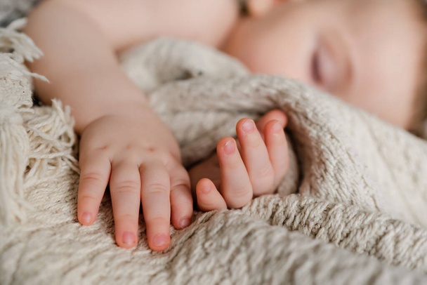 little cute hands of a sleeping baby on a blanket - Фото, изображение