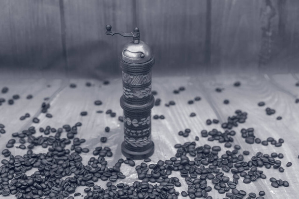 roasted Coffee beans and a vintage coffee grinder - Fotó, kép