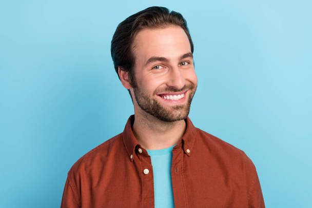 Photo of handsome bristle bearded man smiling stomatology treatment white veneers isolated on blue color background. - Фото, изображение