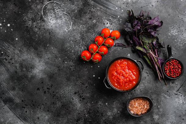 Homemade tomato sauce passata  traditional recipe of italian cuisine set, on black dark stone table background, top view flat lay, with copy space for text - 写真・画像