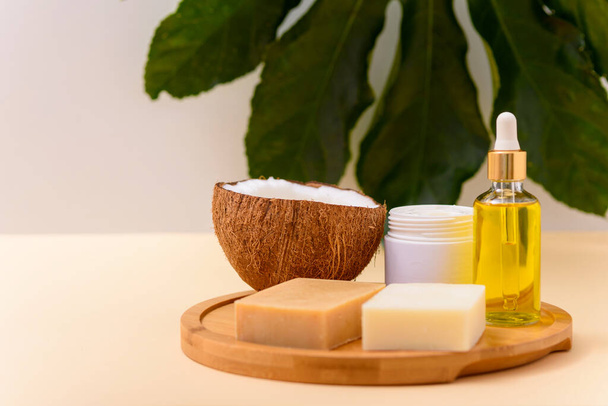 handmade organic cosmetics, natural soap, massage oil, cream on wooden board on beige background, spa day - Photo, Image