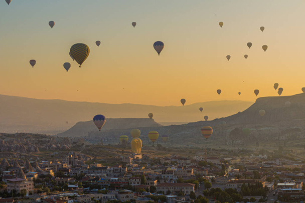 Hot air balloons above Goreme town in Cappadocia, Turkey - 写真・画像