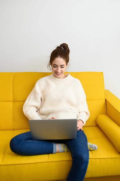 An young woman is using laptop computer for remote work or studying online - Foto, Imagem