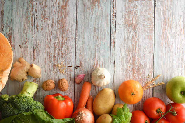 Frame background with fruits and vegetables on unpainted blue wooden table. Top view. Horizontal composition. - Foto, immagini