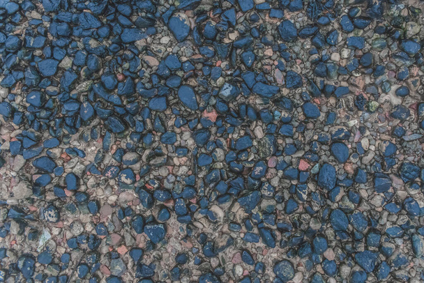 Pebbles dark blue river stone natural background shore surface rough rock. - Photo, Image