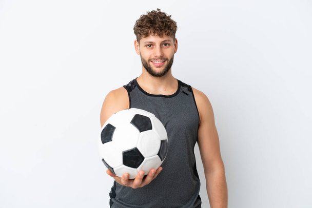 Young handsome caucasian man isolated on white background with soccer ball - Photo, Image