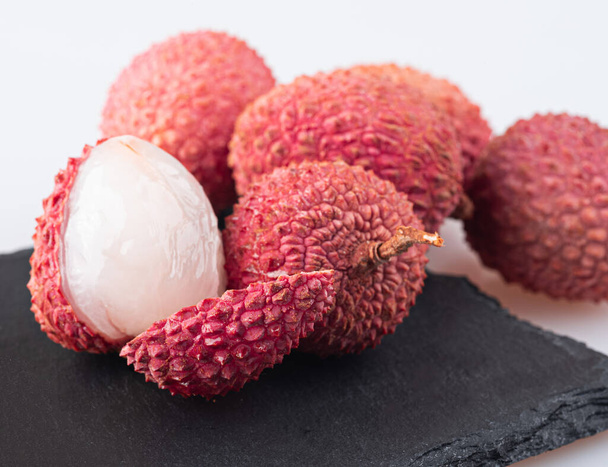 Lychee with peel and peeled lychee isolated on a white background - Foto, Imagem