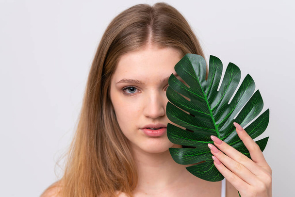 Teenager Russian girl isolated on white background holding a palm leaf. Close up portrait - Φωτογραφία, εικόνα